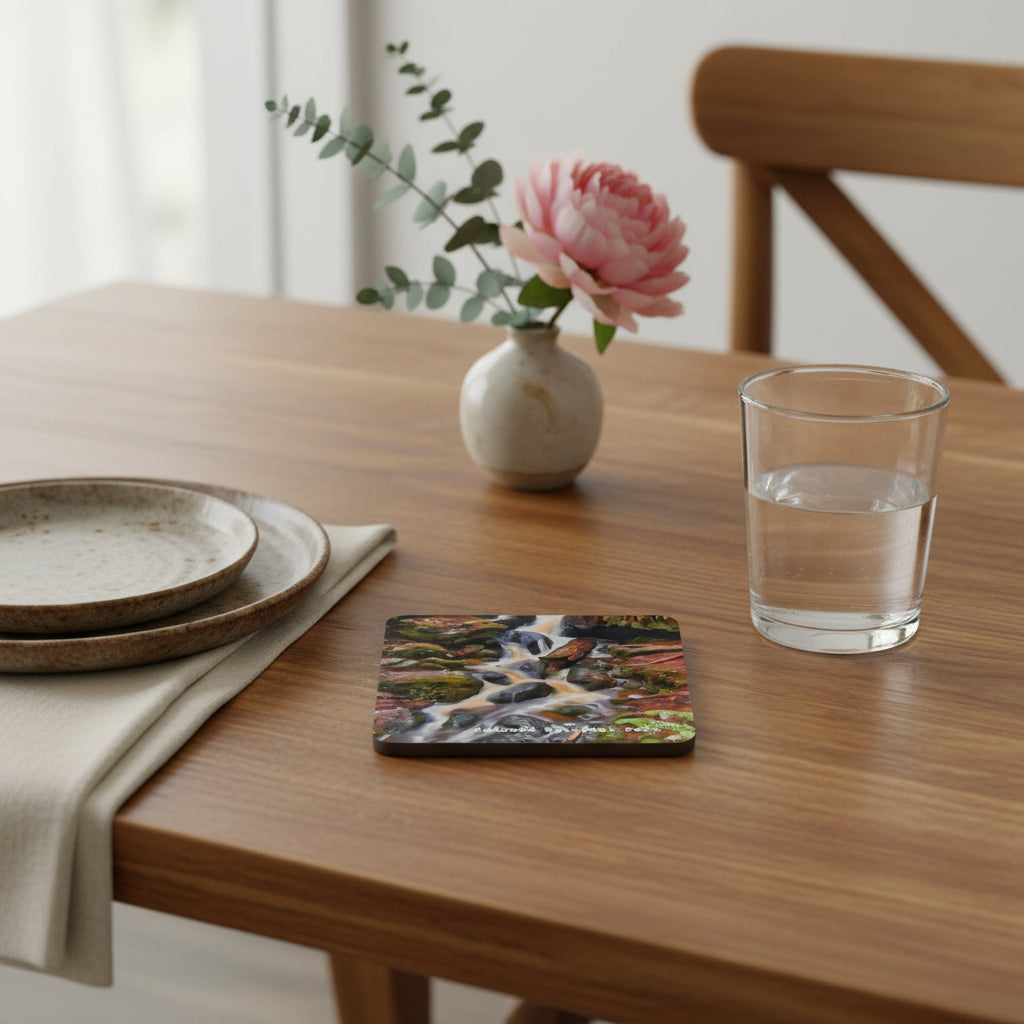 Coaster with a design of a stream and rocks, labeled 'Redwood National Park'. on a dining table