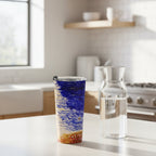 Tumbler with a blue and white abstract design on kitchen counter with a water carafe next to it.  From original painting by Bay Area Artist Marife Rosales of MyLittleFe