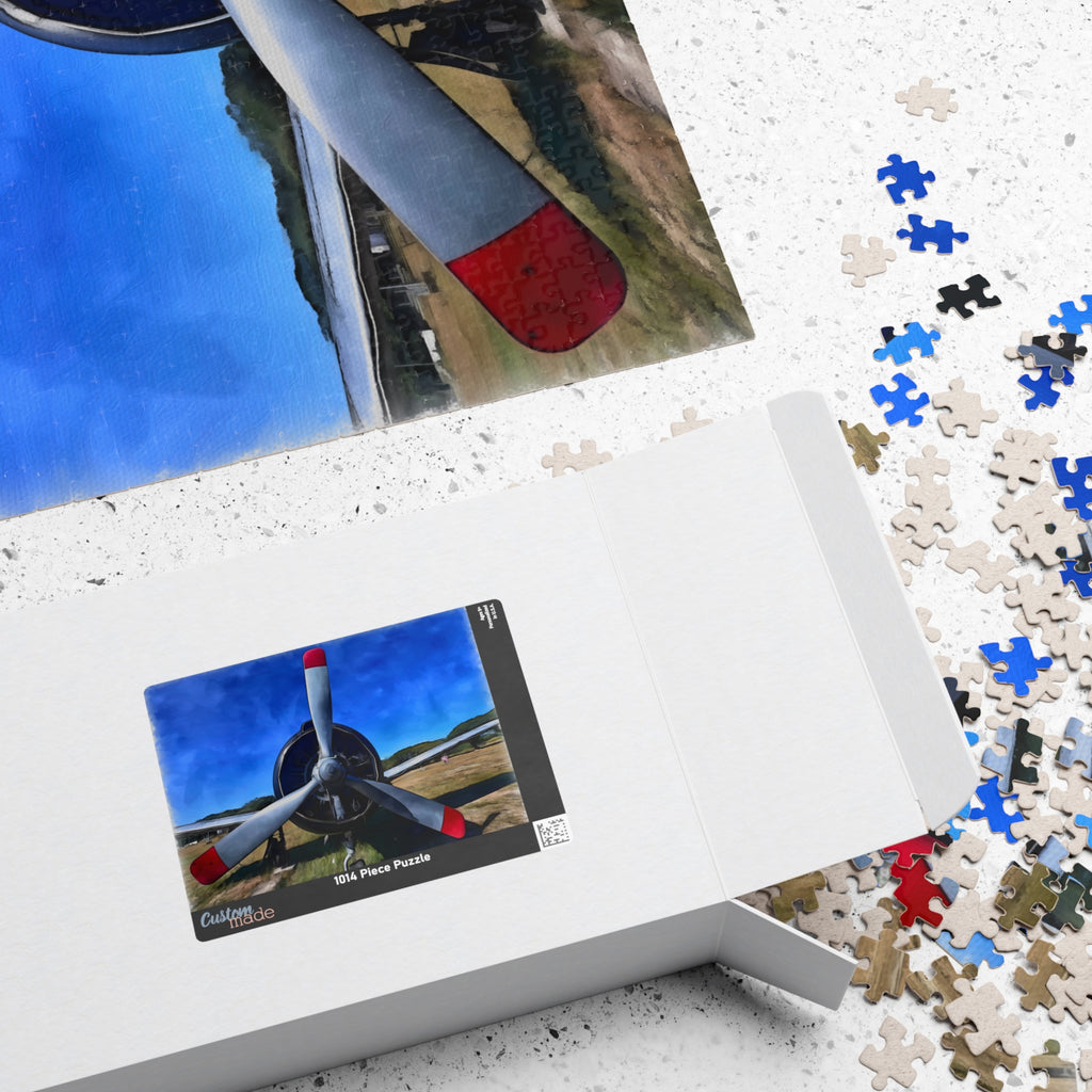 Puzzle box with airplane puzzle pieces and a completed puzzle on a white textured surface.