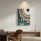 Abstract wall art print featuring concentric coffee-themed circles and a teacup motif, displayed in a modern, sunlit living room setting above a low wooden console table.