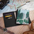 Passport holder with forest design on a map with camera and pen