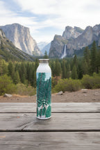 Yosemite Falls with pine trees water bottle on a picnic able with a mountain scene behind