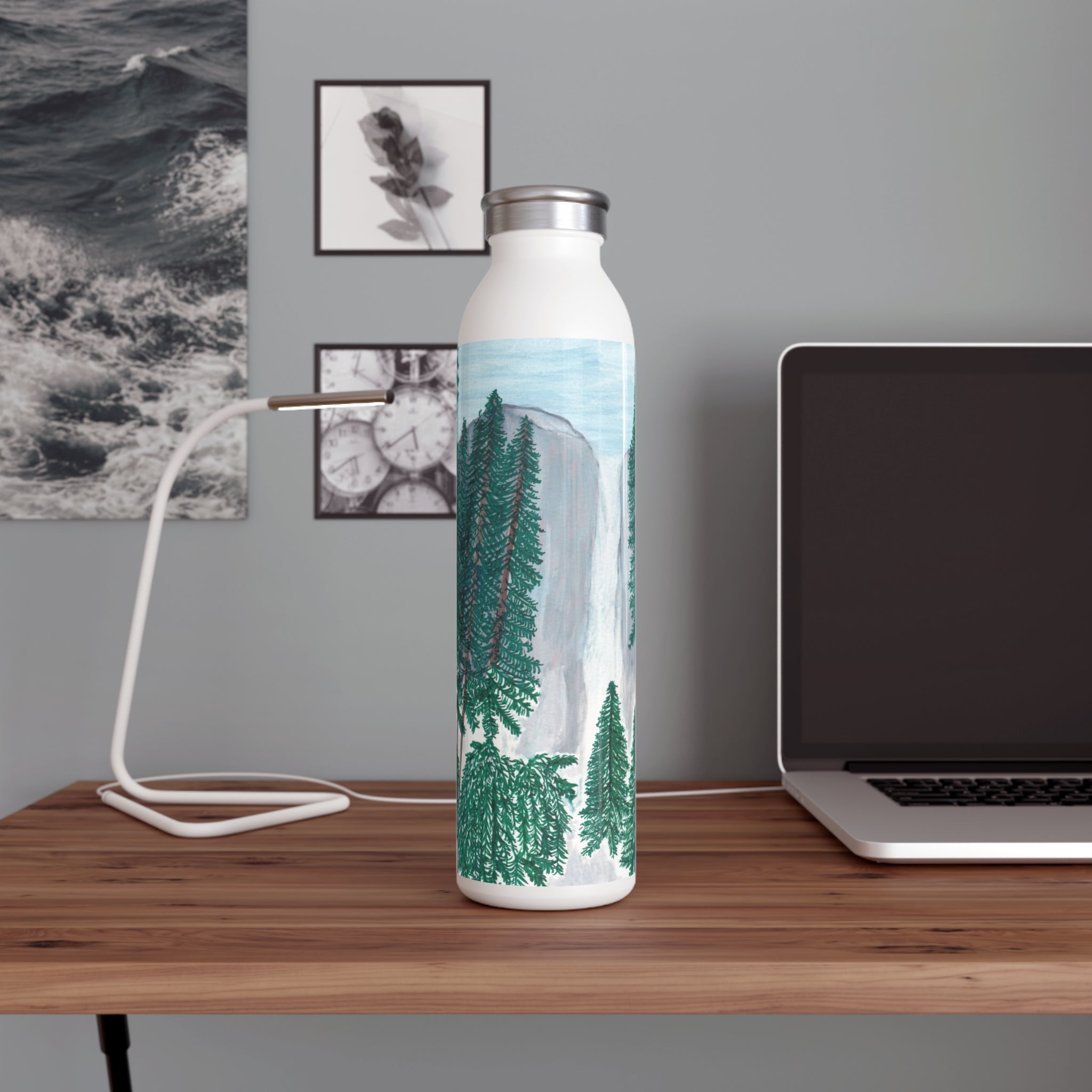 Water bottle with Yosemite Falls Design on a desk next to a laptop.  Designed by Marife Rosales