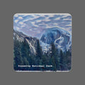 Coaster with a scenic design of Yosemite National Park featuring mountains and trees.