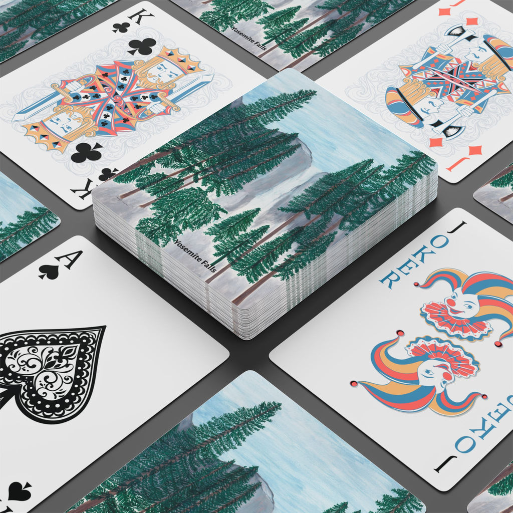 Playing cards with nature-themed design on a black surface