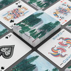Playing cards with nature-themed design on a black surface