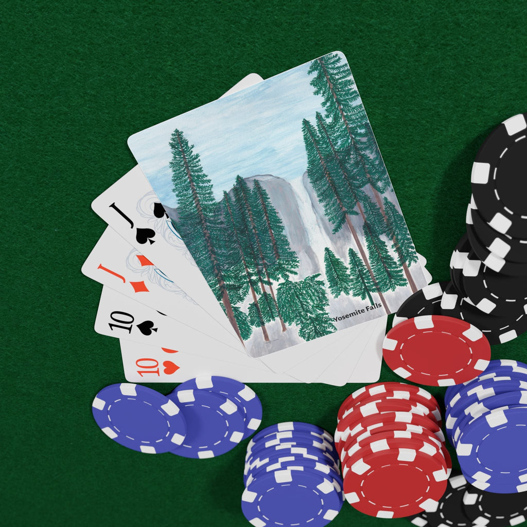 Poker chips and playing cards on a green surface