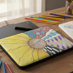 Laptop sleeve with zentangle sunflower design and 'Journey' text on desk with pens and sketchbook