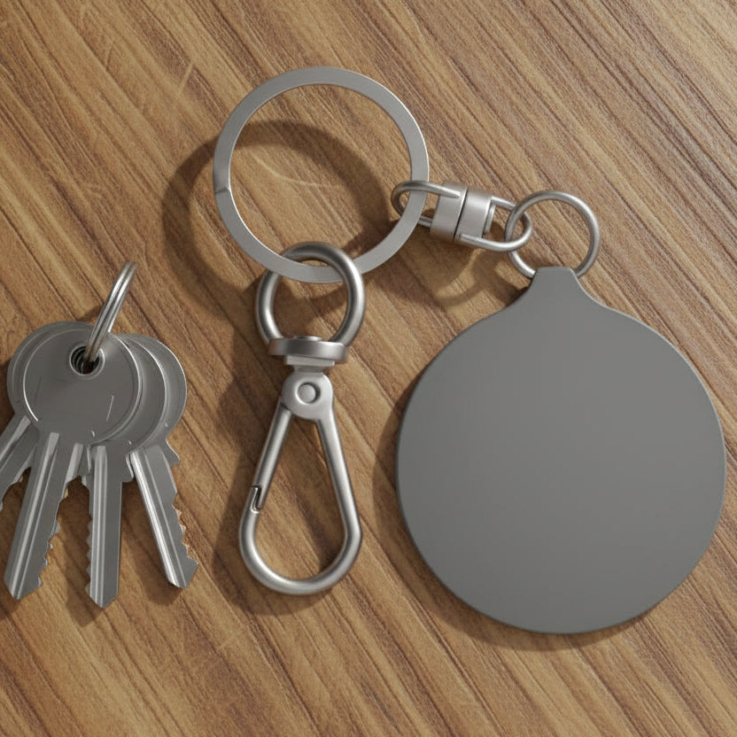 Keychain with keys and a round tag on a wooden surface