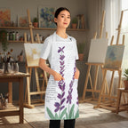 A woman modeling a white apron with a purple lavender floral print and black script text, shown against a plain white background.