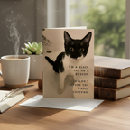 A black and white cat sitting in a beige bathtub with overlaid text that reads, 'I'M A BLACK CAT ON A BUDGET. COULDN'T AFFORD THE WHOLE COSTUME.