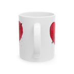 White mug with red heart designs on a white background